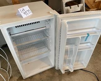 Lot 4879. $75.00  White Haier compact mini refrigerator and freezer compartment with 3.3 cubic feet, perfect for bar area, dorm or small apartment - space saving flat back design. Could use cleaning and labels removed!!    
