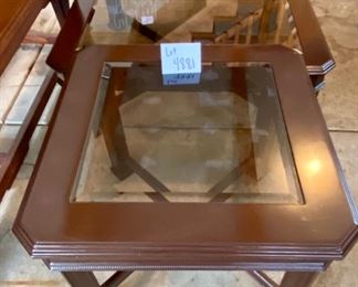 Lot 4881. $195.00  Unbranded but nice wooden cocktail table and side table pair, Dark wood with beveled smoky class inserts.  Very nice shape. Side table: 25.5" Square x  22" H.  Cocktail Table: 40" Square
