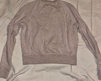 Lot 4899.  $100.00. Lululemon: 4 not so run of the mill sweatshirts! Dark Gray Cropped V-Neck Sweatshirt with bell sleeves, Chrome crop sweatshirt with abstract seams, the softest oatmeal crewneck sweatshirt, and a gathered front punk sweatshirt. All size small. 