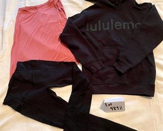 Lot 4892.  $80.00  Lululemon Outfit: 1 pair of black leggings (size 4), 1 dusty rose muscle tank with reflexive letters on the back, and a size 2 Lulu "All Yours" Graphic hoodie in black.  All in excellent condition (but no tags).