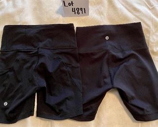 Lot 4891. $80.00  Lululemon: Great workout clothes.  2 pairs of 4" lululemon shorts, size 4 (small) (one has plenty of pockets, both have drawstring waists), 2 ribbed tanks (no bra inserts) and one long-sleeved "swift stride" tech shirt with embroidery. All in excellent condition (but no tags).	