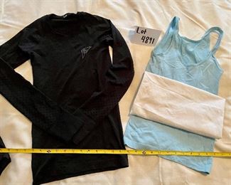 Lot 4891. $80.00  Lululemon: Great workout clothes.  2 pairs of 4" lululemon shorts, size 4 (small) (one has plenty of pockets, both have drawstring waists), 2 ribbed tanks (no bra inserts) and one long-sleeved "swift stride" tech shirt with embroidery. All in excellent condition (but no tags).	