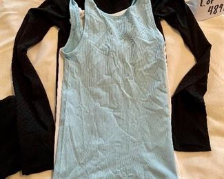 Lot 4891. $80.00  Lululemon: Great workout clothes.  2 pairs of 4" lululemon shorts, size 4 (small) (one has plenty of pockets, both have drawstring waists), 2 ribbed tanks (no bra inserts) and one long-sleeved "swift stride" tech shirt with embroidery. All in excellent condition (but no tags).	Regrets for the wrinkles on this tee.  	