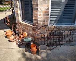Crock, vintage pots, wrought iron fencing, sundial, iron wheels
