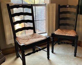 One of 8 black ladder back chairs