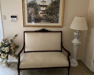 Antique settee; framed art; pedestal; lamp