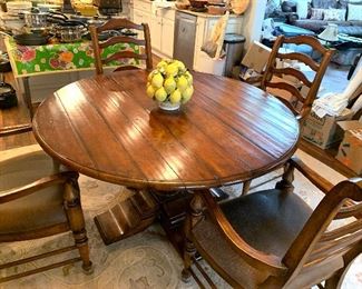 54” round table with 4 leather seat arm chairs