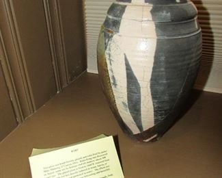 •	Item 9: Signed pottery raku vase by Mike Manning of Canton, Ohio. Approximately 6”wide x 10.5” tall. Scattered crazing from firing. Card with details included. PRICE: $35.00