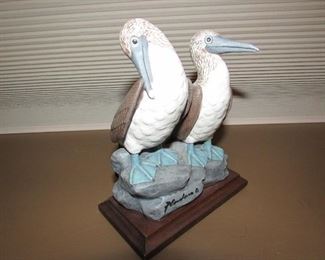 •	Item 13: Signed ceramic small pelican sculpture on wooden base. 5.25”wide x 7”tall x 4”deep. Possible tiny repair to the end of one beak. PRICE: $10.00