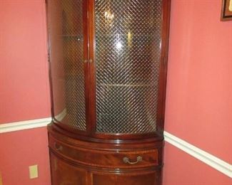 •	Item 35: Vintage Fancher banded mahogany one-piece corner cabinet with curved beveled glass doors. (Not lighted). 21.5” x 9” x 21.5” at back; Approximately 40” across at front; Approximately 23” deep; 74.5” tall. PRICE: $325.00