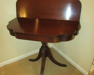 •	Item 43: Vintage carved flip-top mahogany game table. Wear to interior side of flip top. 32” wide x 16” deep x 29.5” tall. Opens to 32” square. PRICE: $125.00