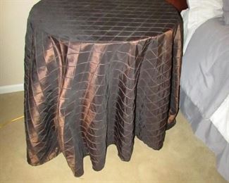 •	Item 75: Designer side table with shiny brown cloth. 28” diameter x 28.5” tall. PRICE: $25.00