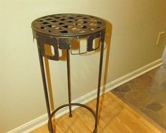 •	Item 82: Patinated metal plant stand. 10.5” diameter x 25.75” tall. PRICE: $20.00