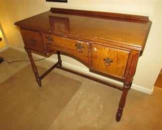 •	Item 87: Vintage vanity with walnut and maple veneers. Some losses to veneers and scattered imperfections. 40” wide x 18.5” deep x 30: Tall. PRICE: $50.00