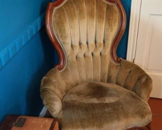 Antique green velvet chair and vintage suitcases