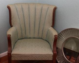 Vintage green upholstered armchair and silver starburst mirror