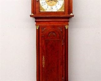 An early 20th century Grandfather clock by Walter H. Durfee, Providence, RI. 8-day weight drive time and strike movement with Brass dial and upper moon phase, Silvered Chapter ring with Arabic numerals, cast dial center and spandrels. Mahogany Chippendale style case, broken arch top with carved griffin masks over a shaped bonnet door with beveled glass, flanked by fluted columns with brass capitols over a arched waist door with carved detail, flanked by fluted columns with carved capitols, over a paneled base with shaped feet. Older refinishing with minor wear, chips on hood returns, feet reduced in height, running when cataloged. 101" high overall. ESTIMATE $3,000-5,000