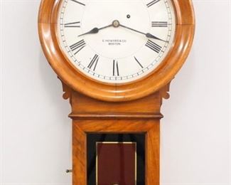 A late 19th century E. Howard & Co. Model 70-12 wall clock. 8-day weight driven time only movement marked "E. Howard & Co. Boston, 59" with 12" painted metal dial and Roman numerals marked "E. Howard & Co. Boston" Brass damascened pendulum. Mahogany case with a circular molded upper door and rectangular lower door with reverse painted glass. Older finish with slight wear, minor paint flakes on dial, running when cataloged. 31" high overall. ESTIMATE $600-800