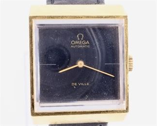 A vintage Omega DeVille wristwatch. Automatic winding movement with square Black dial and thick beveled crystal in a 27 mm gold filled case with replaced leather strap. Case unopened, some wear, scratch on rear cover, running when cataloged. ESTIMATE $200-300