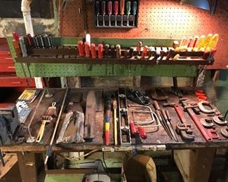 Large variety of vintage and current hand tools, bench vice and work bench