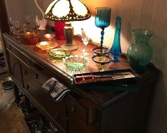 Tiffany lamp, Green and pink Depression glassware and fluted vases  on top of the wooden Buffet