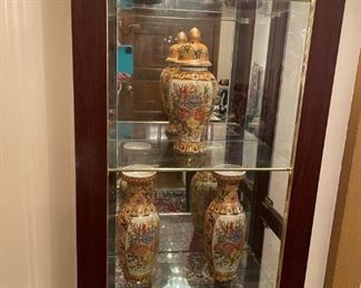 ORIENTAL VASES AND EGGS IN CURIO CABINET
