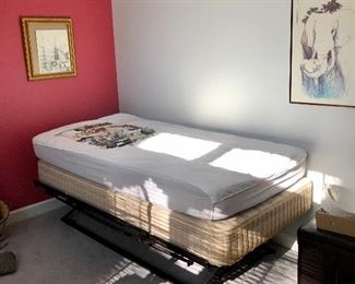 Twin box springs and mattress on metal frame.