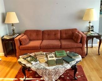Two side tables, one of 2 sofas, drop sides coffee table, lamps, vintage books and historic railroad and local book, large cherry blossom rug