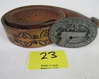 Vintage 1985 belt buckle w/leather belt. Belt measures 57"