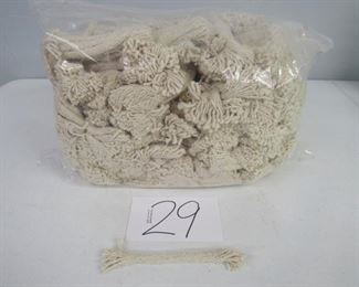 Very large bagged lot of cotton wicks. There are hundreds of wicks. The wicks are in bundles within the bag. 