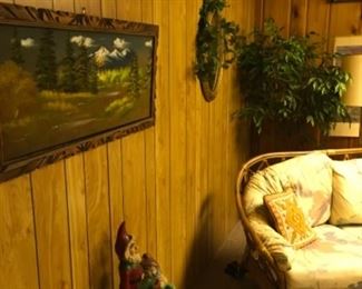 Rattan couch, end tables, pictures, wind chimes, gnomea
