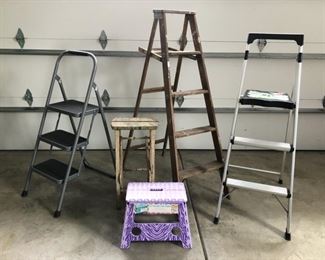 Assorted folding ladders and step stools. The two metal ladders have sold