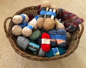 Assorted skeins of wool yarn. Basket sold separately