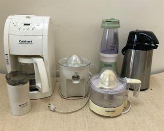 Assorted small appliances including Cuisinart coffee maker, Braun Citromatic juicer, Black & Decker Handy Juicer, Black & Decker Coffee Mill and a bullet-style blender!
