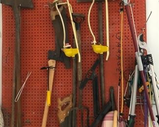 Garden tools including spade, ax, saws, loppers, shovels and lawn sprinklers