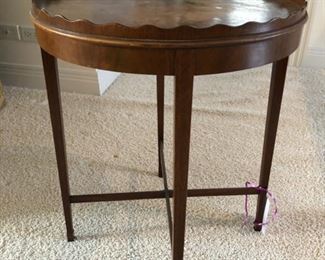 Antique scallop edge side table. Measures 25" H with a 21" diameter. Top needs refinishing or paint for a more modern feel