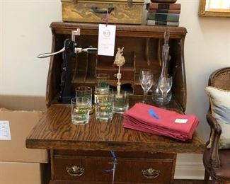 Antique clawfoot drop-leaf desk measures 48" H x 29.5" W x 19" D, vintage suitcase, set of 6 Sunset Ridge Country Club low ball glasses, Screw Pull wine opener, wine decanter and set of 6 new Daisy Hill linen napkins