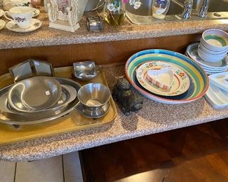 Vintage stainless serving pieces, modern colorful dishes.