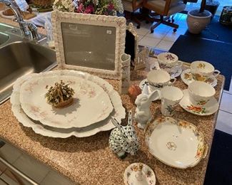 Decorative bone china platters, picture frame, tea sets.