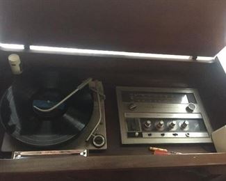 interior of great old stereo  by GE , with turntable and radio , more stereo items too