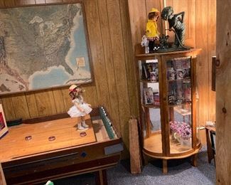 oak curved cabinet with Shirley Temple collectibles and large game table American Shuffleboard table with metal pucks 