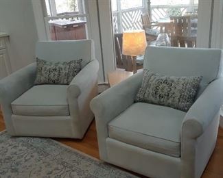 Pair of custom upholstered swivel chairs