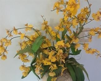 Floral arrangement of faux orchids