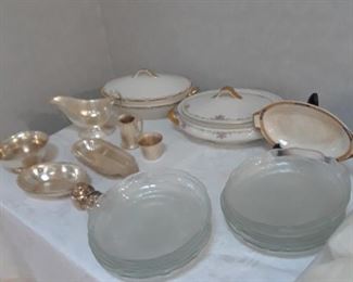 Covered vegetable bowls, glass salad plates, silverplated serving pieces