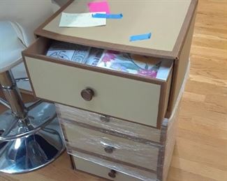 Canvas covered 4-drawer chest filled with paper napkins, plates and cutlery for parties