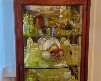 Great oak China/display case loaded with Vaseline  glass of all types. 
