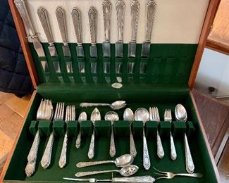 $1,750 - International Silver "Treasure"; 58 piece set includes: (4) each - cocktail fork, espresso spoon, small soup, grapefruit spoon, dinner fork, salad fork, desert fork, teaspoons, dinner knife, luncheon knife, spork.  (5) iced tea spoon, (2) each - soup spoons, serving spoons, large serving spoons, (1) each - serving fork, pickle fork, slotted spoon, sugar shell, carving set
