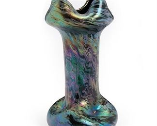 2004
A Loetz Pinched Four-Corner Style Iridescent Glass Vase
Late 19th/early 20th Century; Bohemia (Czech Republic)
The Art Nouveau purple, blue, and black vase with ribbon-style rim
7" H x 3.625" Dia.
Estimate: $300 - $500