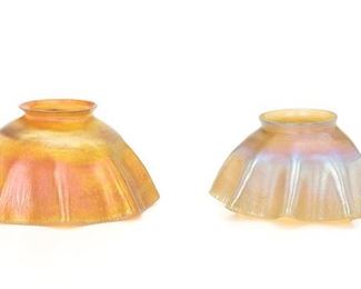 2008
Two Tiffany Favrile Lamp Shades
Late 19th/early 20th Century
One signed: L.C.T.
Each eight-sided with scalloped rim and onion skin surface texture, comprising one orange iridescent shade (3.5" H x 6.75" Dia.) and one gold iridescent shade (3.125" H x 5.875" Dia.), 2 pieces
Estimate: $500 - $700