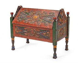 2057
An Indonesian Carved Wood Slant-Top Trunk
20th Century
The polychromed carved wood trunk with geometric and stylized floral patterning raised on straight legs with ball finials and tapered feet
22.5" H x 26.375" W x 15" D
Estimate: $400 - $600